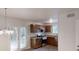 Well-appointed kitchen featuring stainless steel appliances, dark wood cabinetry, and a charming chandelier at 1169 Oaks Pl, Stone Mountain, GA 30083