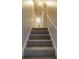 Carpeted stairway with white railing leads to upper level, illuminated by overhead lighting at 1169 Oaks Pl, Stone Mountain, GA 30083