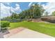 Well-manicured backyard featuring a green lawn, mature trees, and a charming wooden fence for privacy at 2895 Dominion Walk Ln, Snellville, GA 30078