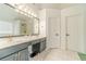 This bathroom offers double sinks, neutral counters and floors, and great light at 2895 Dominion Walk Ln, Snellville, GA 30078