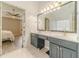 This bathroom offers double sinks, neutral counters and floors, and access to bedroom at 2895 Dominion Walk Ln, Snellville, GA 30078