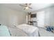 A cozy bedroom features a ceiling fan, television, a sleek desk, and a calming gray color palette at 2895 Dominion Walk Ln, Snellville, GA 30078
