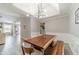 Bright dining room features unique wood table, modern chandelier and wainscoting detail at 2895 Dominion Walk Ln, Snellville, GA 30078