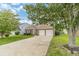 Well-kept brick home boasting a two-car garage and lush green lawn at 2895 Dominion Walk Ln, Snellville, GA 30078