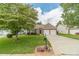 Beautiful brick home with a manicured lawn, flowers, and a two-car garage at 2895 Dominion Walk Ln, Snellville, GA 30078