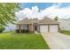 Charming single-story brick home featuring a well-manicured lawn and a two-car garage at 2895 Dominion Walk Ln, Snellville, GA 30078