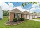 Well-maintained brick home featuring black shutters and manicured landscaping at 2895 Dominion Walk Ln, Snellville, GA 30078