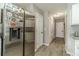 Galley kitchen with stainless steel refrigerator and access to storage and hallway at 2895 Dominion Walk Ln, Snellville, GA 30078