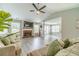 Spacious living room with brick fireplace, large windows, neutral colors, and ceiling fan at 2895 Dominion Walk Ln, Snellville, GA 30078