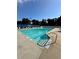 Community swimming pool with ladder, lounge seating, and clear signage for depth and safety at 2895 Dominion Walk Ln, Snellville, GA 30078