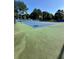Community tennis court is ready for play, with trees providing nice shading, and dark blue fencing at 2895 Dominion Walk Ln, Snellville, GA 30078