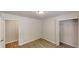 A simple bedroom with wood-look floors and adjacent full bathroom and closet at 366 O Brian Dr, Stone Mountain, GA 30088