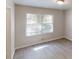 Bedroom with light-colored walls, wood-look flooring and a large window at 366 O Brian Dr, Stone Mountain, GA 30088