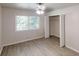 A bright bedroom with wood-look floors, closet, large window and ceiling fan at 366 O Brian Dr, Stone Mountain, GA 30088