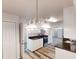 Kitchen with dark granite countertops, white cabinetry, stainless steel appliances, and hardwood style flooring at 366 O Brian Dr, Stone Mountain, GA 30088