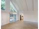 Open living room features vaulted ceiling, hardwood floors, and an adjacent modern kitchen at 366 O Brian Dr, Stone Mountain, GA 30088