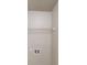 Storage room with single shelf and hookups for washer and dryer at 488 Barclay Ct, Stone Mountain, GA 30083