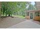 Expansive backyard featuring mature trees, a screened porch, and a small wooden deck at 501 Bridlepath Ln, Peachtree City, GA 30269