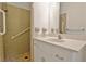 Bathroom with tiled shower, handrails, and vanity with ample counter space at 501 Bridlepath Ln, Peachtree City, GA 30269