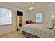 Cozy bedroom with light colored walls and wood-look flooring, ceiling fan and space for an office at 501 Bridlepath Ln, Peachtree City, GA 30269
