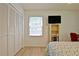 Bedroom with a closet and light colored wood-look flooring and a place for a TV at 501 Bridlepath Ln, Peachtree City, GA 30269