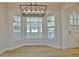 Inviting breakfast nook with large windows, new light fixture, and wood flooring at 501 Bridlepath Ln, Peachtree City, GA 30269