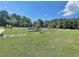 Expansive community green space featuring a playground, tennis court, and benches at 501 Bridlepath Ln, Peachtree City, GA 30269