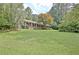Beautiful brick home with a large front yard and lush trees, offering a serene setting at 501 Bridlepath Ln, Peachtree City, GA 30269