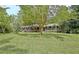 Lovely brick home with black shutters and well-maintained lawn surrounded by mature trees at 501 Bridlepath Ln, Peachtree City, GA 30269