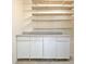 White workshop cabinets and shelves in the garage at 501 Bridlepath Ln, Peachtree City, GA 30269