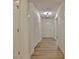 Hallway featuring wood look vinyl floors, closet for storage and modern ceiling light fixture at 501 Bridlepath Ln, Peachtree City, GA 30269