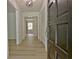 Inviting hallway with neutral walls and wood-look floors, leading to other rooms at 501 Bridlepath Ln, Peachtree City, GA 30269