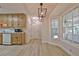 Kitchen view with breakfast nook, featuring oak cabinetry, white appliances, and door access at 501 Bridlepath Ln, Peachtree City, GA 30269