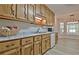 Charming kitchen with oak cabinets, updated countertops, and stainless steel sink at 501 Bridlepath Ln, Peachtree City, GA 30269