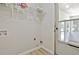 Bright laundry room offers vinyl floors, wire shelving for storage, and easy access to adjacent sunroom at 501 Bridlepath Ln, Peachtree City, GA 30269