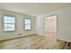 Bright living room showcasing wood-look floors, two windows, and an open doorway at 501 Bridlepath Ln, Peachtree City, GA 30269