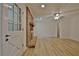 Cozy living room with brick fireplace, light flooring, and seamless access to the front porch at 501 Bridlepath Ln, Peachtree City, GA 30269