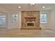 Inviting living room with brick fireplace, wood floors, and natural light at 501 Bridlepath Ln, Peachtree City, GA 30269