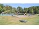 A community playground includes a tennis court, multiple playground features, and a grassy field at 501 Bridlepath Ln, Peachtree City, GA 30269