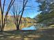 Scenic view of a pond reflecting the surrounding trees with autumn foliage at 501 Bridlepath Ln, Peachtree City, GA 30269