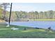 Scenic pond view with a wooden bridge and ducks on the grassy bank at 501 Bridlepath Ln, Peachtree City, GA 30269