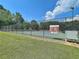 Community tennis court surrounded by fencing, with an adjacent green space at 501 Bridlepath Ln, Peachtree City, GA 30269