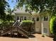 Beautiful backyard with tiered wooden deck, surrounded by lush greenery and mature trees at 605 Meadows Creek Dr, Johns Creek, GA 30005