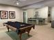 A finished basement featuring a pool table, a bar area, and ample space for recreation and entertainment at 605 Meadows Creek Dr, Johns Creek, GA 30005