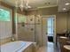 A spacious bathroom with double sinks, a standalone shower, and a soaking tub, creating a spa-like experience at 605 Meadows Creek Dr, Johns Creek, GA 30005