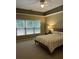 A bright bedroom with neutral color scheme and a large window for natural light at 605 Meadows Creek Dr, Johns Creek, GA 30005
