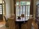 Elegant dining room features a large round table, shuttered windows, and sophisticated decor at 605 Meadows Creek Dr, Johns Creek, GA 30005