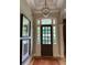 Grand foyer with elegant chandelier, dark wood door, and beautiful sidelights at 605 Meadows Creek Dr, Johns Creek, GA 30005