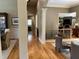 Spacious hallway with hardwood floors, columns, and views into the dining and living spaces at 605 Meadows Creek Dr, Johns Creek, GA 30005