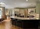 Open kitchen features granite countertops, island with seating, and stainless steel appliances at 605 Meadows Creek Dr, Johns Creek, GA 30005